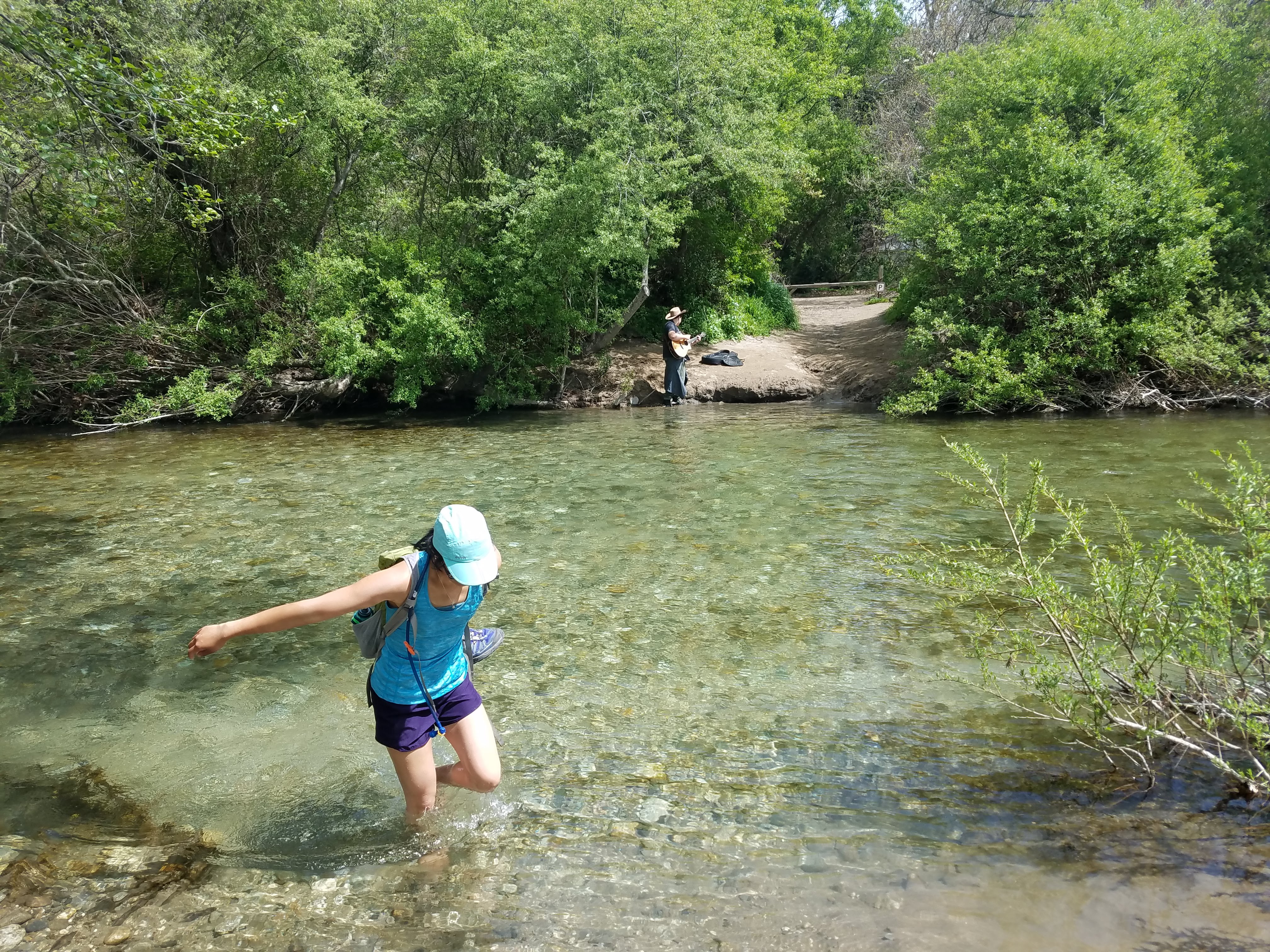 Wading across a creek to get to the beach at Andrew Molera state park.